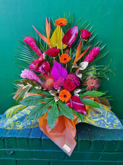 Tropical vibes - This tropical arrangement is made in floral foam, it contains lots of exotic fresh flowers and decorative  foliage. if your looking for the wow factor, this will give you it!