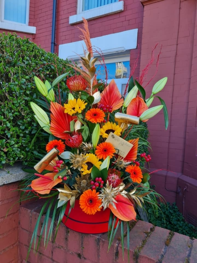 luxury hat box - This floral arrangement is made in a hat box, it certainly gives the wow factor! it contains flowers such as sun flowers, lilies, gerbera, anthurium, dried spear palms and gold foliage.